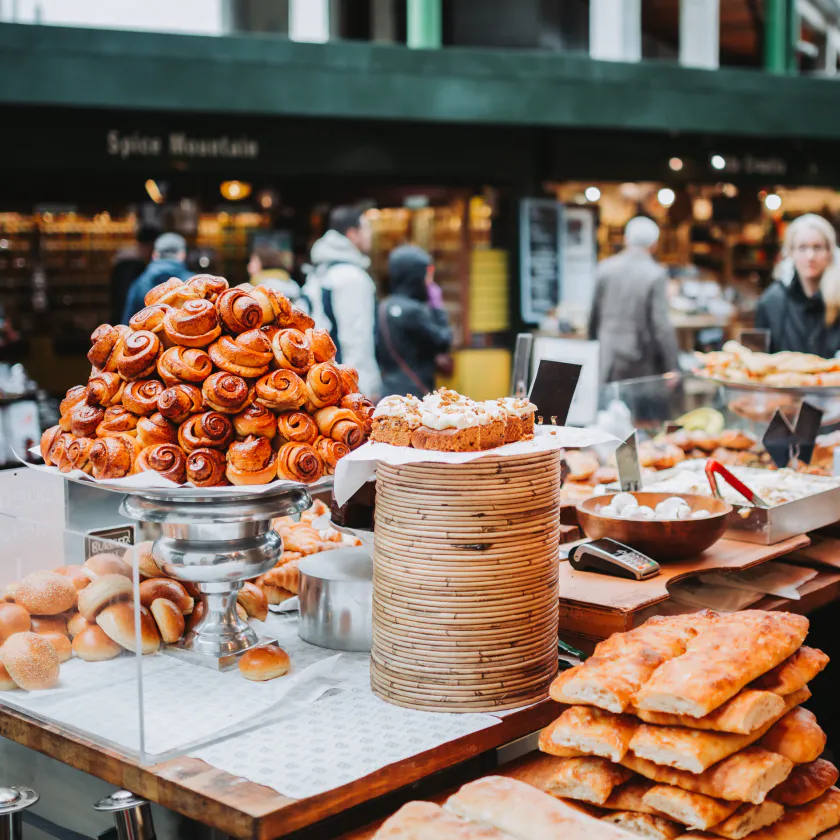Assorted pastries on a counter-top, in a busy shopping street